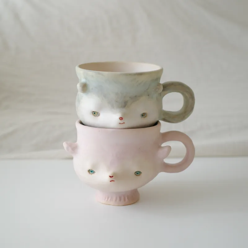 微笑んでいたり、むくれていたり、表情豊かなface MUG